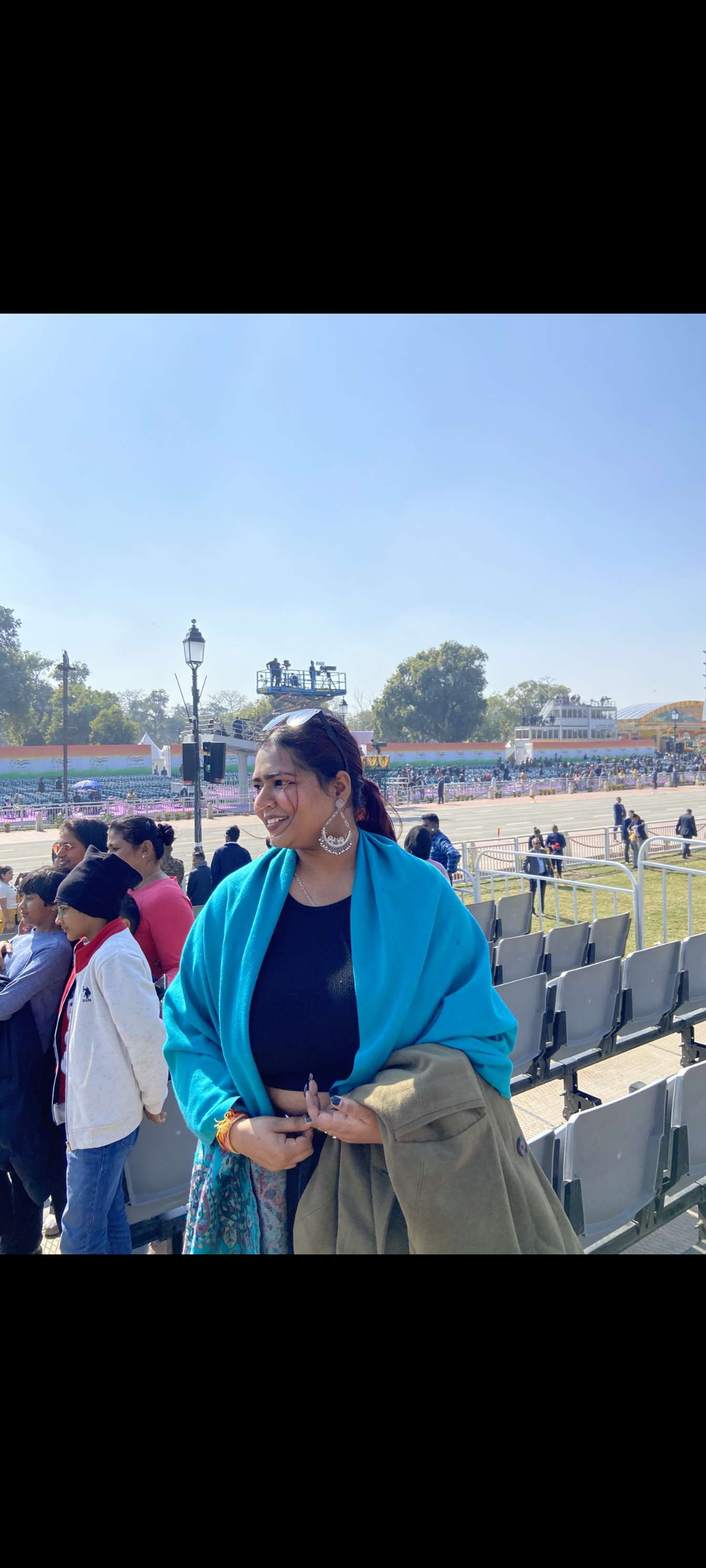 Archita Rajput smiling outdoors in a blue shawl